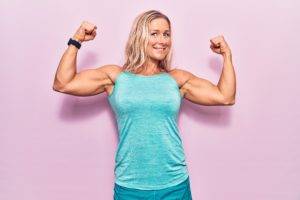 middle age woman showing the importance of protein flexing